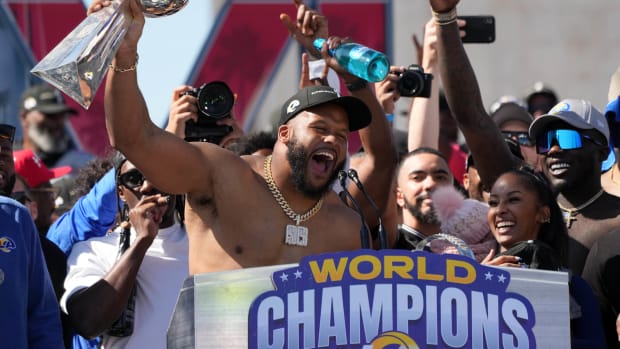Feb 16, 2022; Los Angeles, CA, USA; Los Angeles Rams defensive end Aaron Donald holds the Vince Lombardi trophy during the Super Bowl LVI championship rally at the Los Angeles Memorial Coliseum. Mandatory Credit: Kirby Lee-USA TODAY Sports